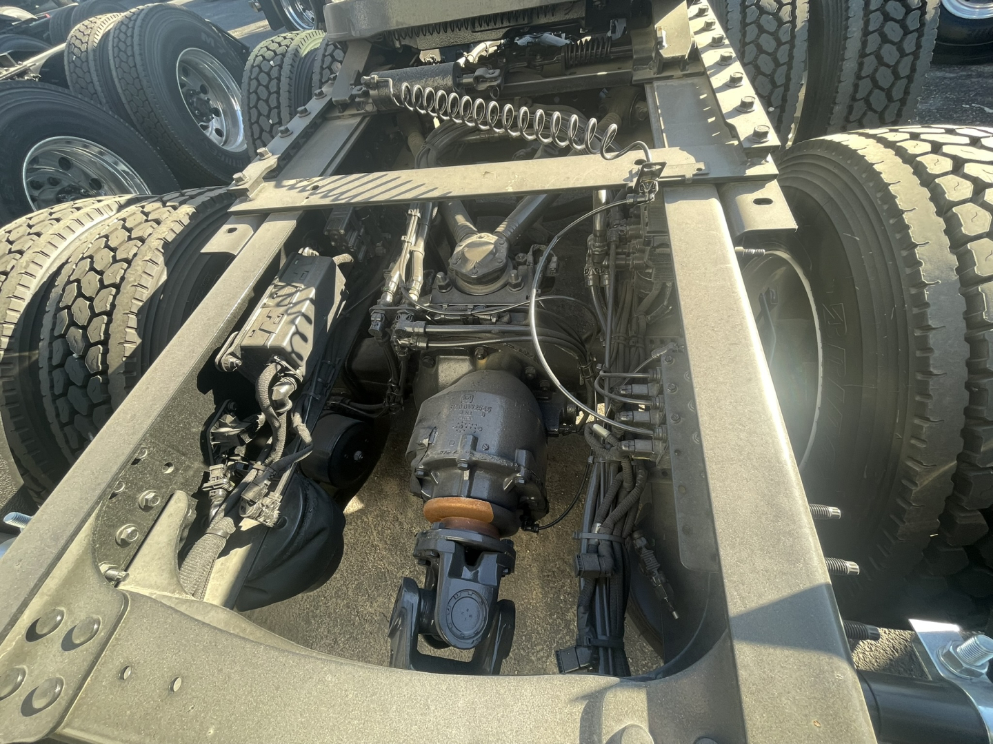 Volvo VNL54/VNL64 truck chassis showing drivetrain and air lines with fifth wheel and rear suspension, engine bay obscured.