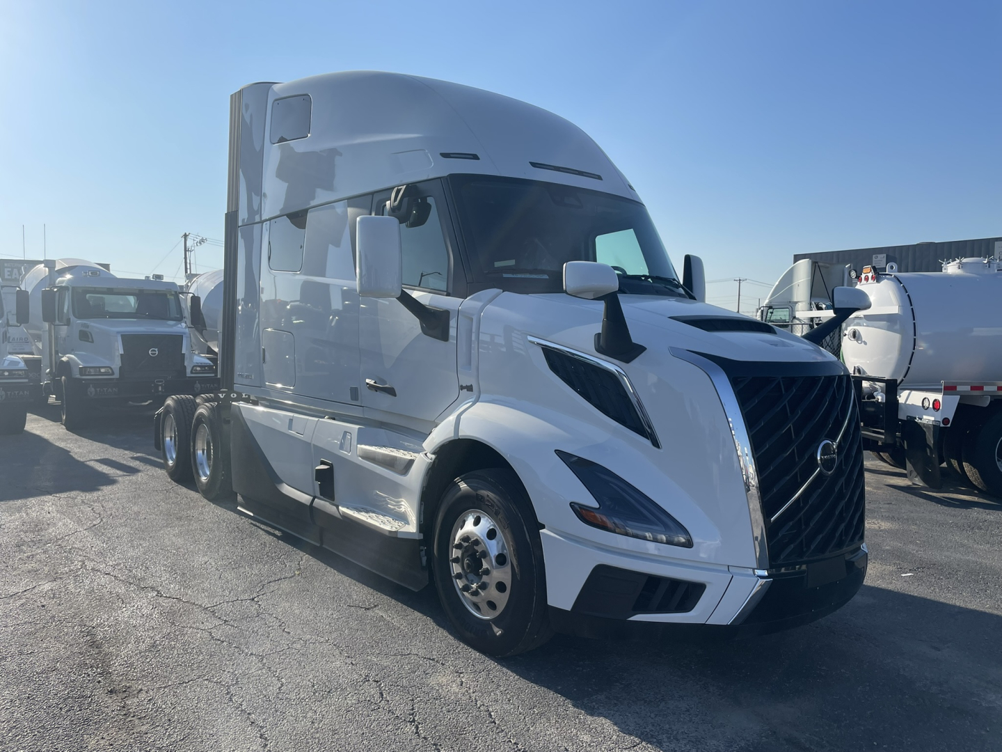 Volvo VNL64T860 conventional sleeper truck in white, exterior view from left front angle showing aerodynamic hood, grille, headlights, and side mirrors.