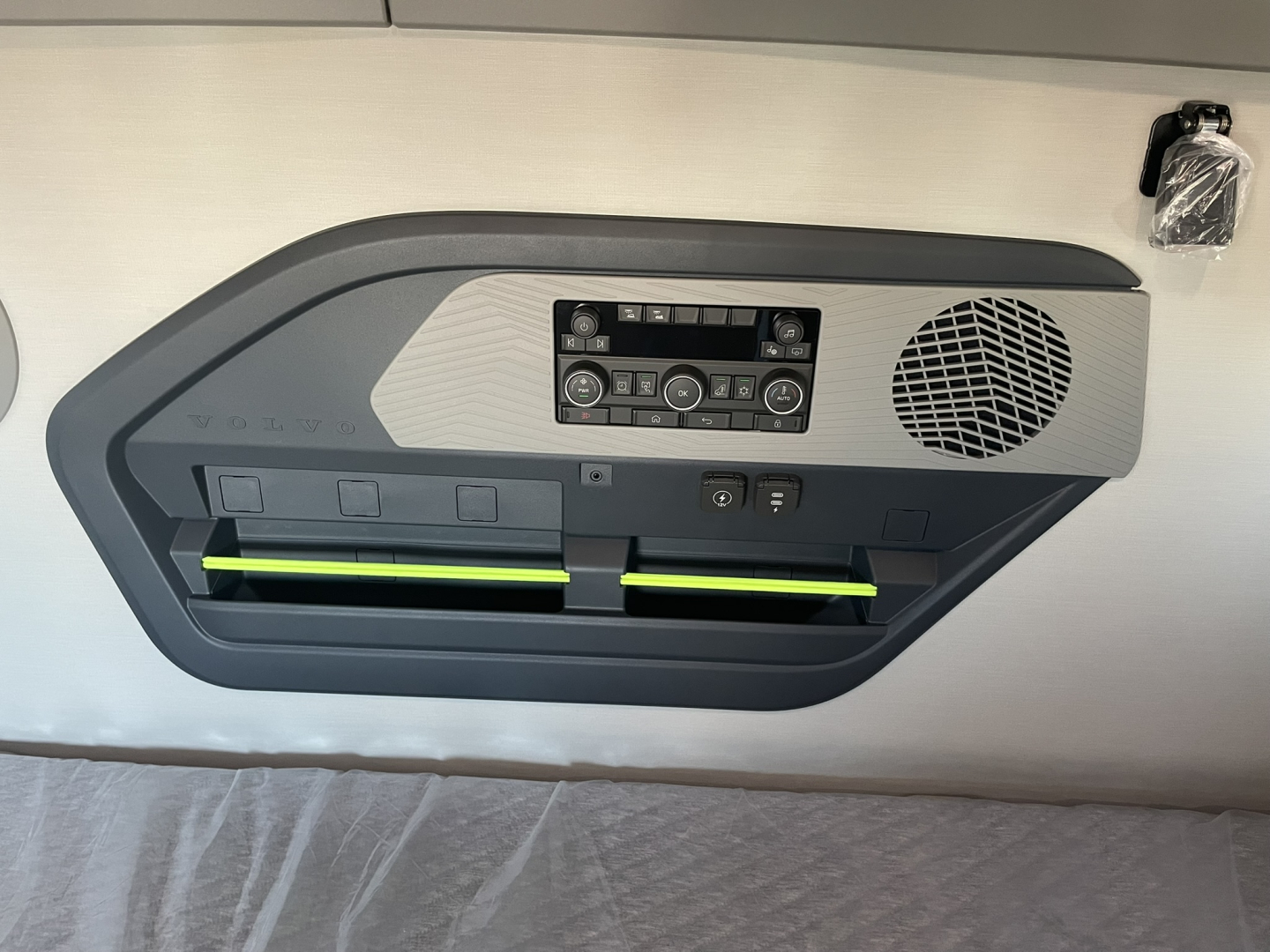 Volvo VNL64T860 sleeper truck interior panel showing control console and two green-lighted storage slots.