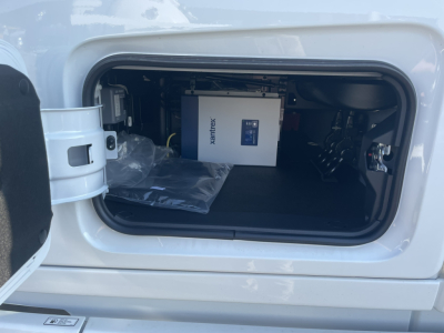 Volvo VNL64T860 cab access showing battery/in-cab equipment in storage bay with XENTREX box.