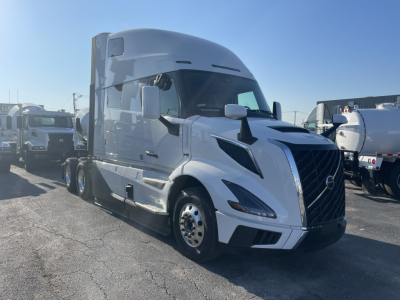 Volvo VNL64T860 conventional sleeper truck in white, exterior view from left front angle showing aerodynamic hood, grille, headlights, and side mirrors.