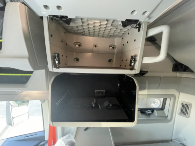 Volvo VNL64T860 sleeper cab interior showing overhead storage compartments and a lower dash storage bin.