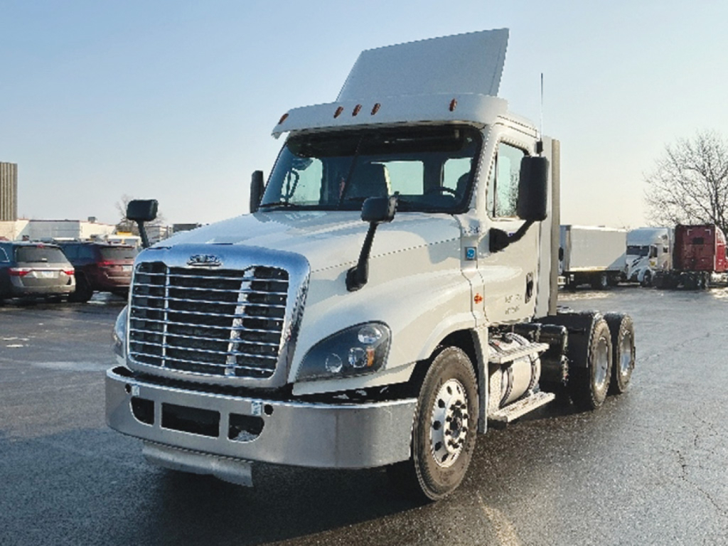 Truck cab and tractor rear chassis of a 2019 Freightliner Cascadia125 convention daycab showing front grille, headlights, and raised sleeper/hood with a white paint job.