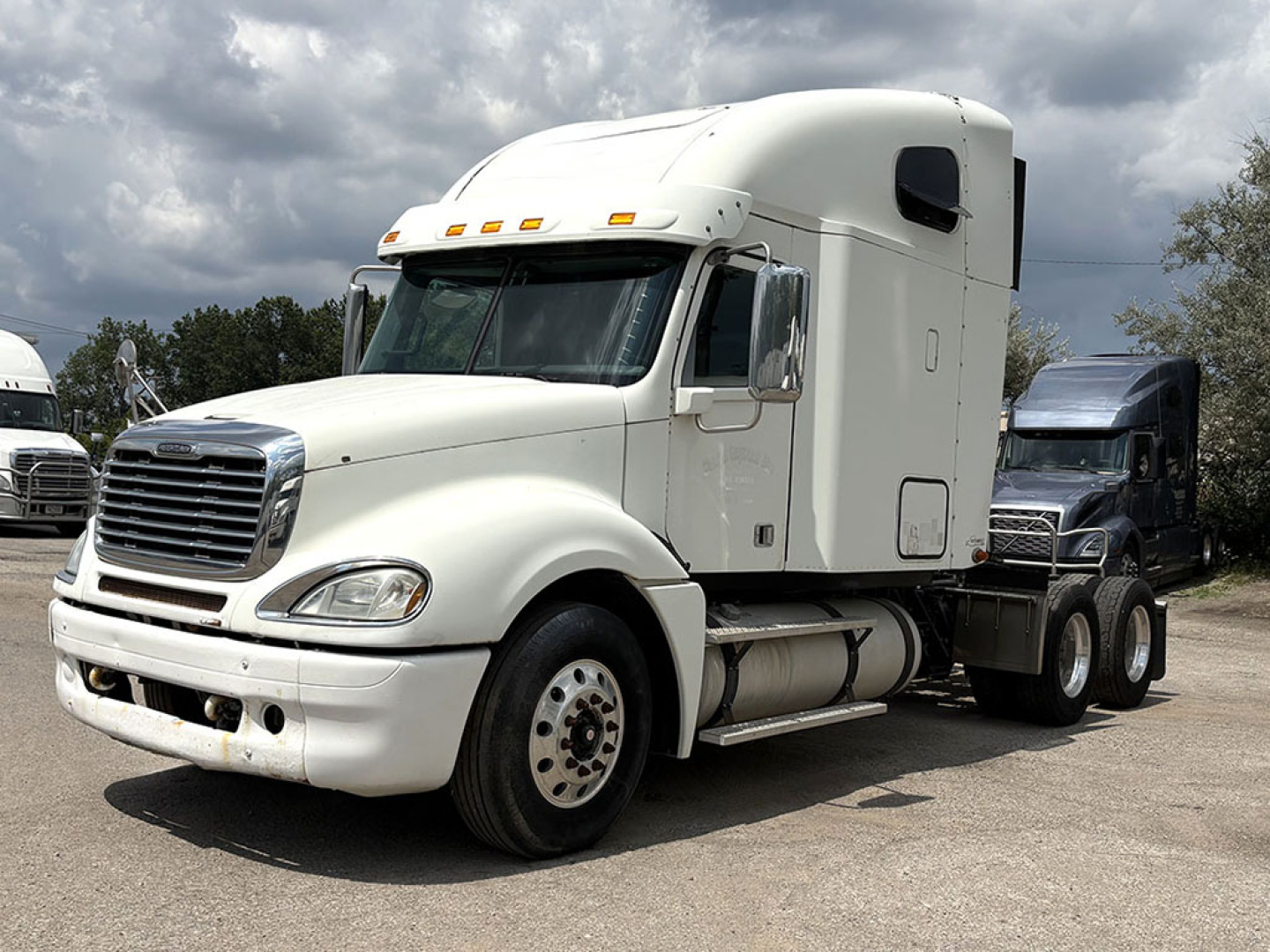 Freightliner CL120 Columbia sleeper cab tractor showing front and side profile with white paint and chrome grille.