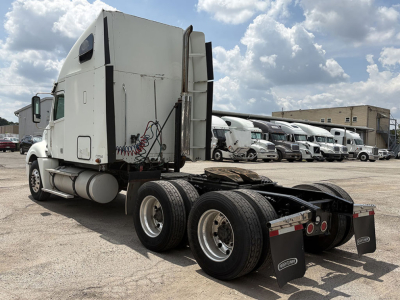 Truck tractor with sleeper cab, rear view showing dual rear axles and fifth wheel chassis in a used Freightliner CL120 Columbia configuration.
