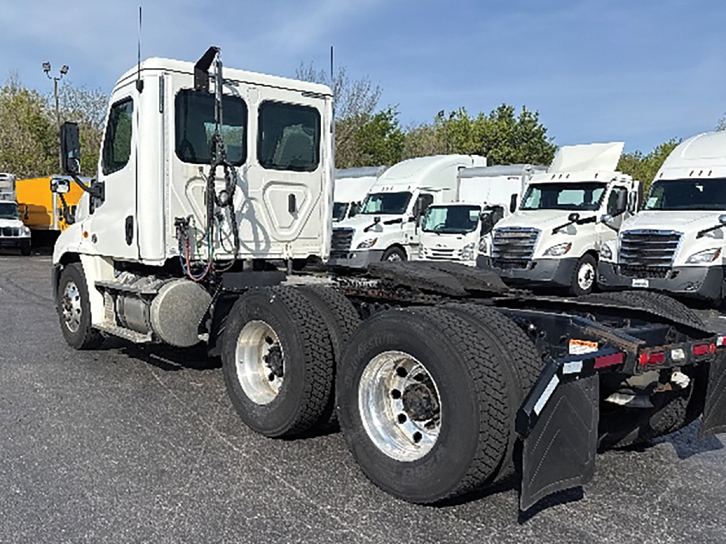 Truck tractor showing side view of rear chassis and dual rear axles with tires, Freightliner Cascadia125 used listing.