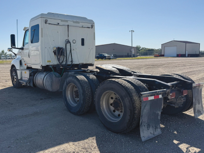 Truck rear and cab of a 2021 International LT625 tractor. Visible features include dual rear axles with mud flaps, fifth wheel area, fuel tanks, and side mirrors. No legible text on components in view.