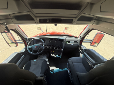 Kenworth T680 interior cab view from front seats showing dashboard, steering wheel, and side mirrors.