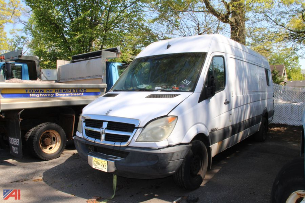 Dodge Sprinter cargo van in a lot showing front-left angle with a raised roof and white body.