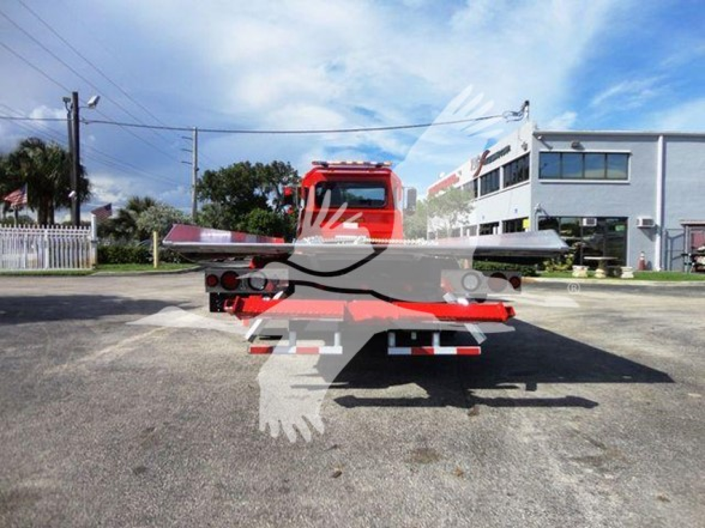 Truck bed of a 2022 Peterbilt 337 rollback chassis showing flatbed and rear lights.