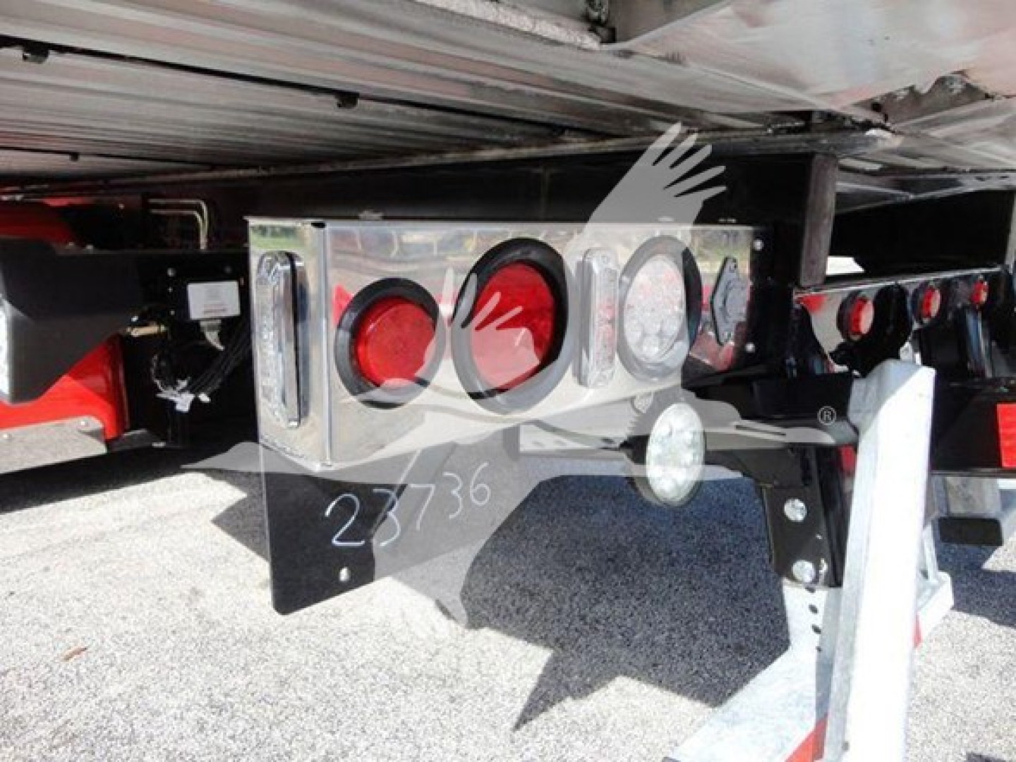 Rear of a 2022 Peterbilt 337 rollback truck showing chrome bumper with three circular lights and hitch area.
