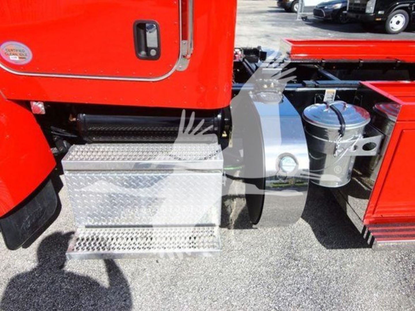 Peterbilt 337 rollback truck side view showing exterior fuel/air lines, chrome diamond-plate steps, and side toolbox adjacent to cab.
