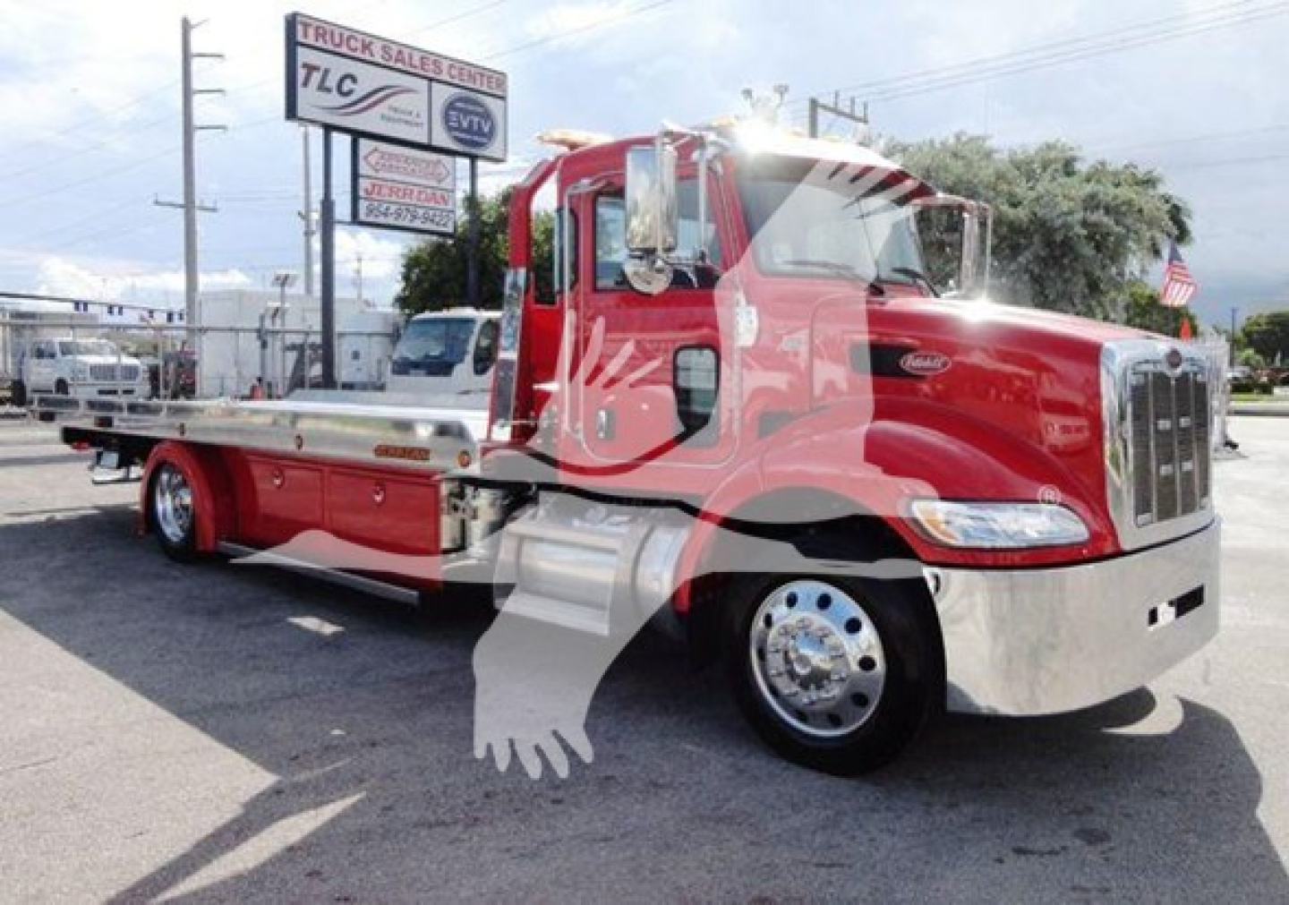 Peterbilt 337 rollback truck in red with flatbed, front chrome bumper and cab, side view showing VIN placard and stock number
