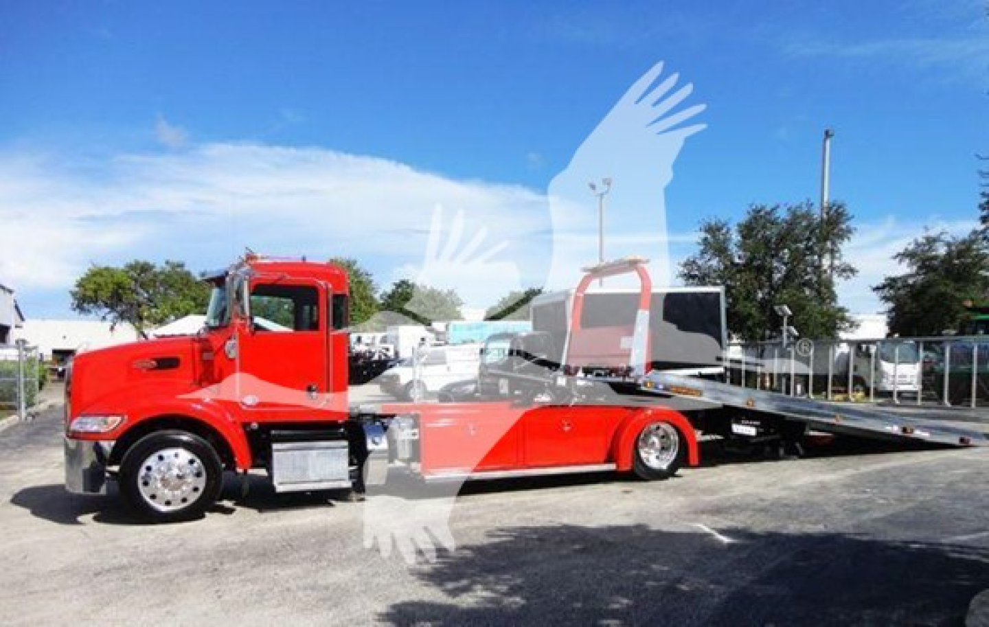 Peterbilt 337 rollback truck with red cab and flatbed tow bed shown in side view.
