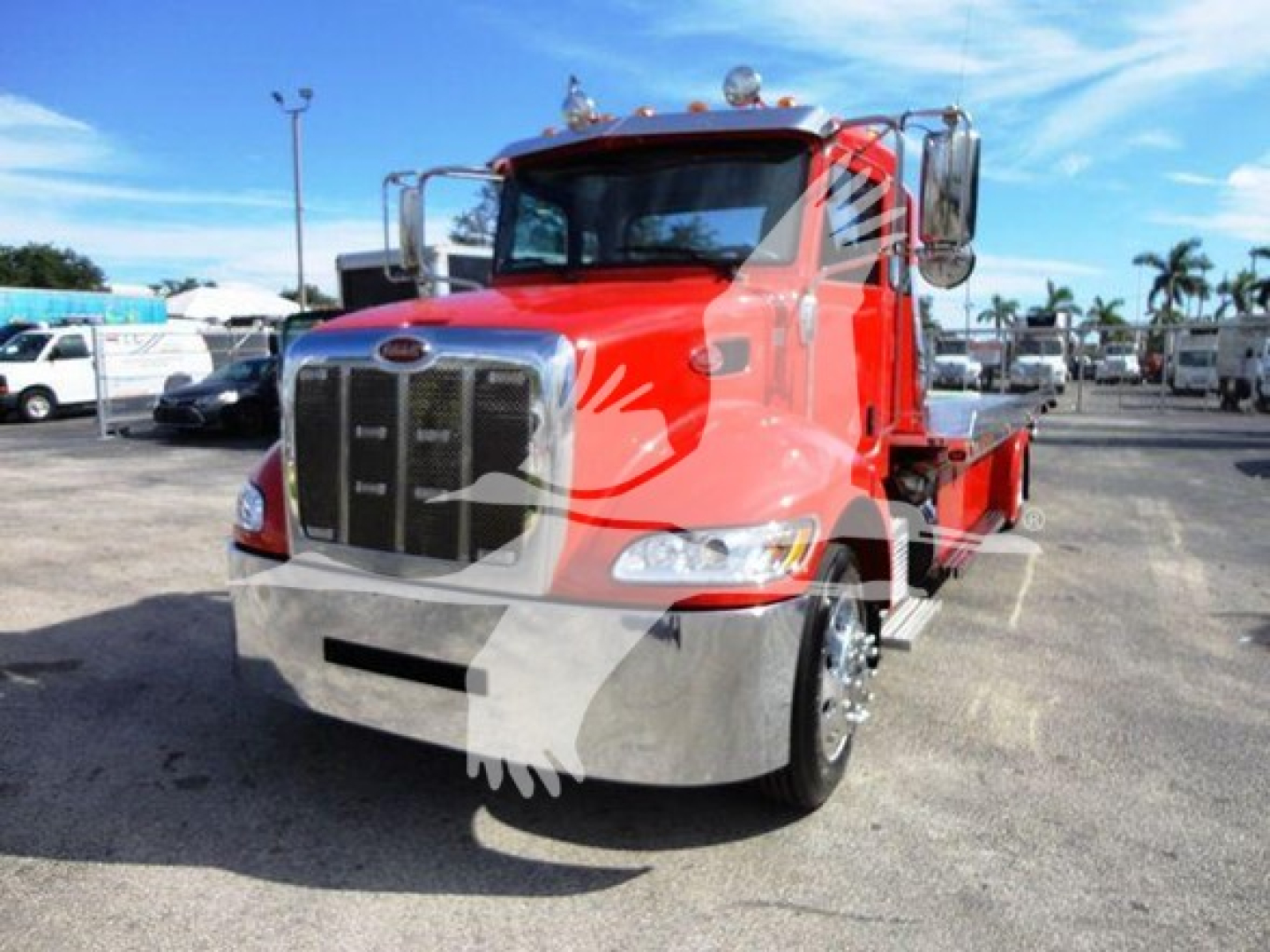 Peterbilt 337 rolled back truck in red with chrome grille, cab mirrors, and black bumper.