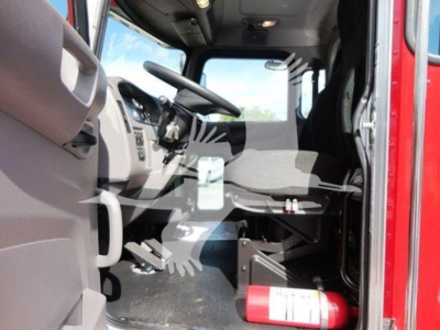 Trucks cab interior of 2022 Peterbilt 337 rollback showing steering wheel, dashboard, driver's seat, and fire extinguisher mounted near floor.