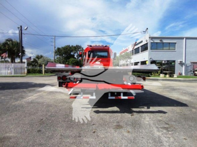 Truck bed of a 2022 Peterbilt 337 rollback chassis showing flatbed and rear lights.