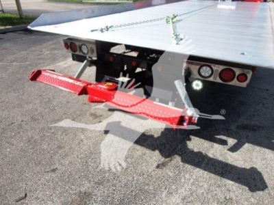 Rear view of a 2022 Peterbilt 337 rollback flatbed with red wheel-lift attachment and tail lights visible.