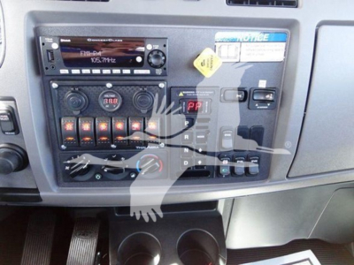 Peterbilt 337 dashboard with radio, climate controls, and gear selector visible, including button panel and digital readouts.