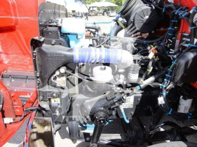 Peterbilt 337 engine bay showing coolant hose, air filter, and various hoses and wiring harness.