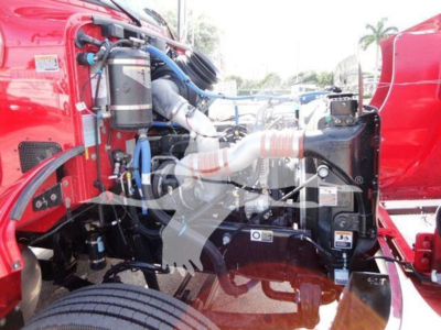 Peterbilt 337 engine bay view showing various components and hoses in red truck, starting near left side with air filter canister and intake pipes.