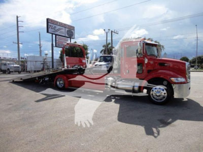 2022 Peterbilt 337 rollback truck with red cab and flatbed, VIN 2NP2HM6X1NM761992, stock J61992, in-service vehicle listing image.