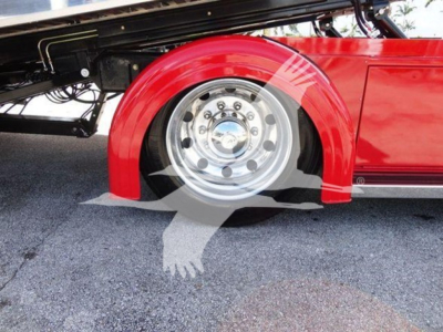 Peterbilt 337 rollback truck wheel and red fender with chrome hub showing undercarriage details.