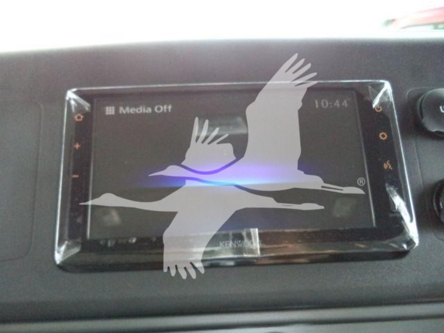 Dashboard touchscreen display in a Freightliner M2 106 showing Media Off, with protective plastic film still on screen.