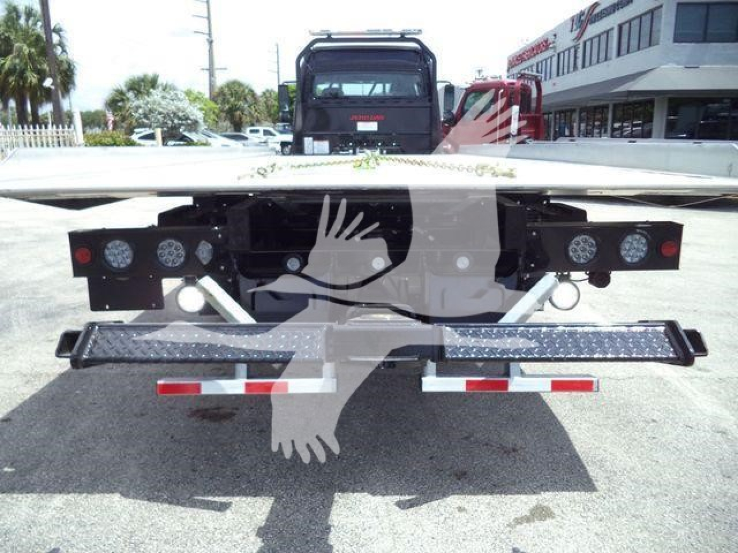 Freightliner M2 106 rollback rear view showing rear bumper, lights, and towing hitch area.