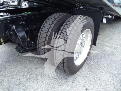 Freightliner M2 106 truck rear dual wheels and chassis shown, heavy-duty tires, black undercarriage, chrome wheel rims.