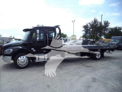 Freightliner M2 106 rollback truck in a dealership lot with text overlays showing a watermark and a long flatbed.