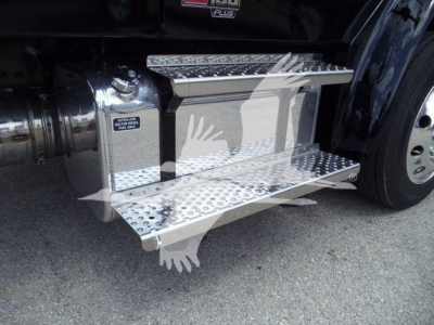 Freightliner M2 106 truck side view showing polished aluminum retractable drop steps with textured treads and a portion of the fuel/air intakes; visible wheel and chrome accents.