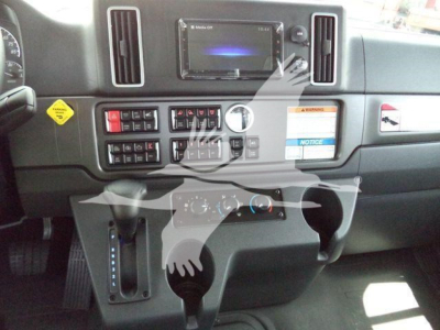 Dashboard view of a Freightliner M2 interior with center touchscreen, air vents, climate controls, and gear selector visible.