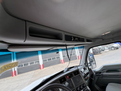 Kenworth T880 cab interior showing instrument cluster, dash controls, and overhead compartments.