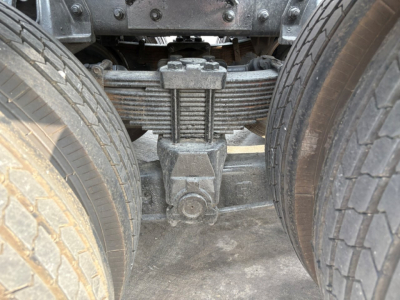 Kenworth T880 axle with drive axles and suspension showing leaf spring pack and differential housing.