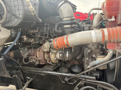 Kenworth T880 engine bay with turbocharger and intake piping visible.
