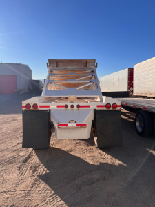 Manac light weight bottom dump trailer rear view showing mud flaps and ladder frame