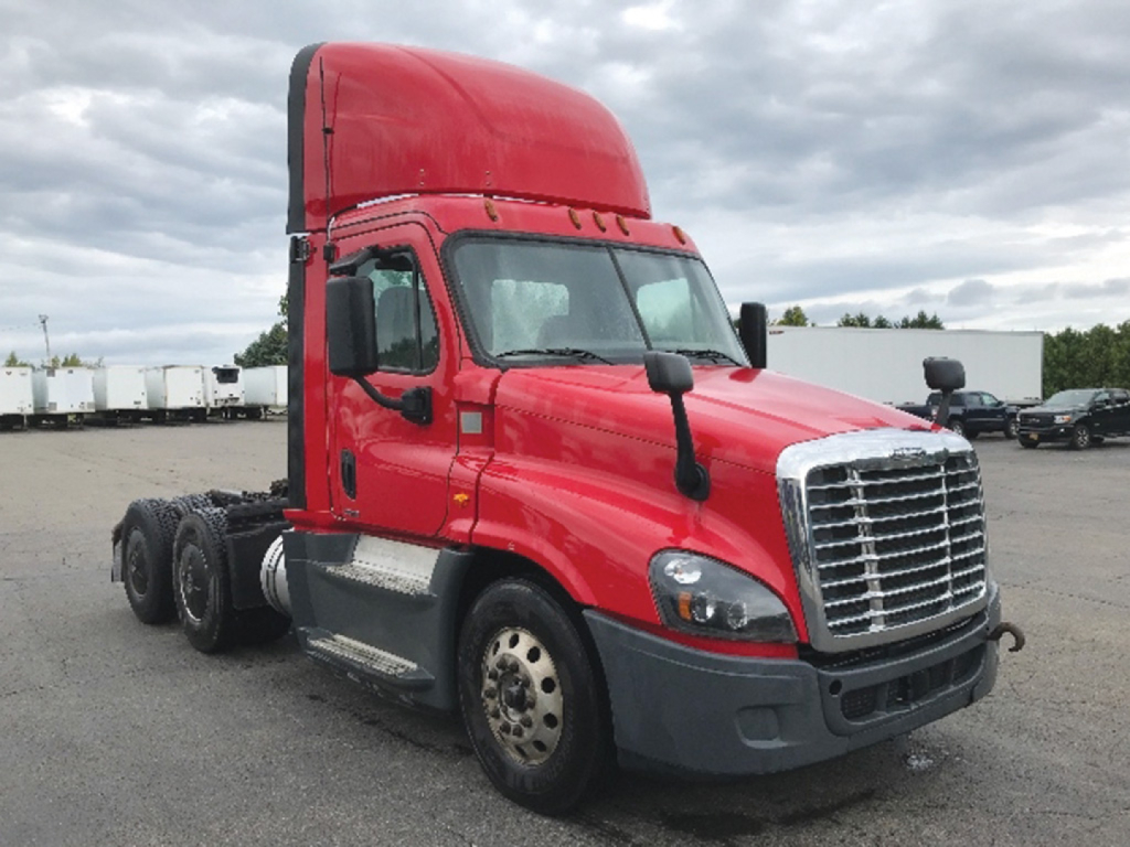 Truck cab showing 2018 Freightliner Cascadia125 daytime cab with red exterior and chrome grille.