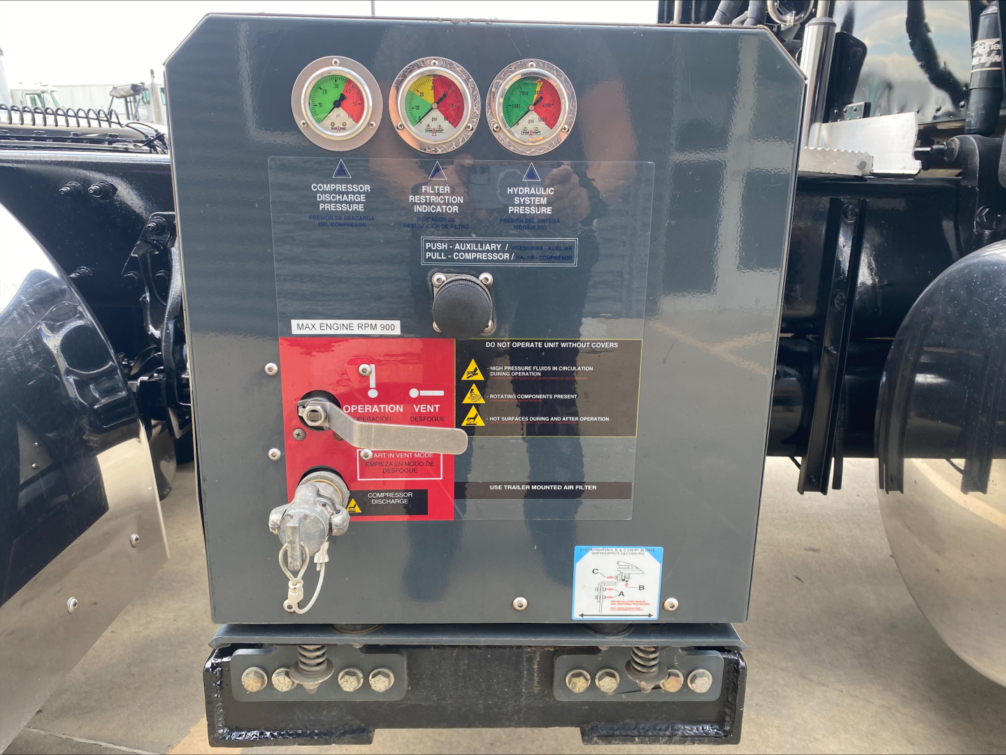 Peterbilt 389 engine bay/converter panel with gauges and control levers labeled, including red control panel with labels and key lock