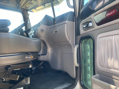 Peterbilt 389 truck interior cabin view with driver seat and dashboard details visible.