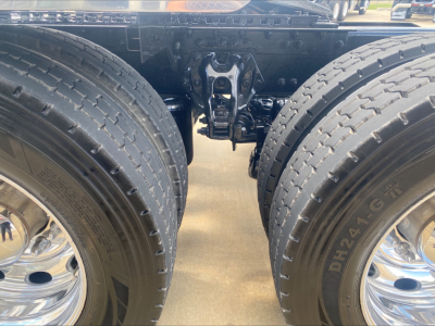 Peterbilt 389 truck rear wheels and suspension view showing dual rear axles and sixth-wheel area; no text visible.