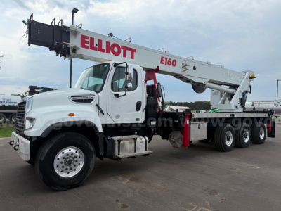 Heavy-duty boom truck with white cab and extended gray crane labeled E160, red Elliott branding on boom, multiple axles, side steps, and storage compartments.