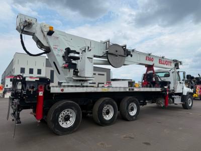 Truck-mounted crane on a Freightliner 114SD with long flatbed; equipment labels and crane arm visible, including E160 and ELLIOTT branding on the crane.