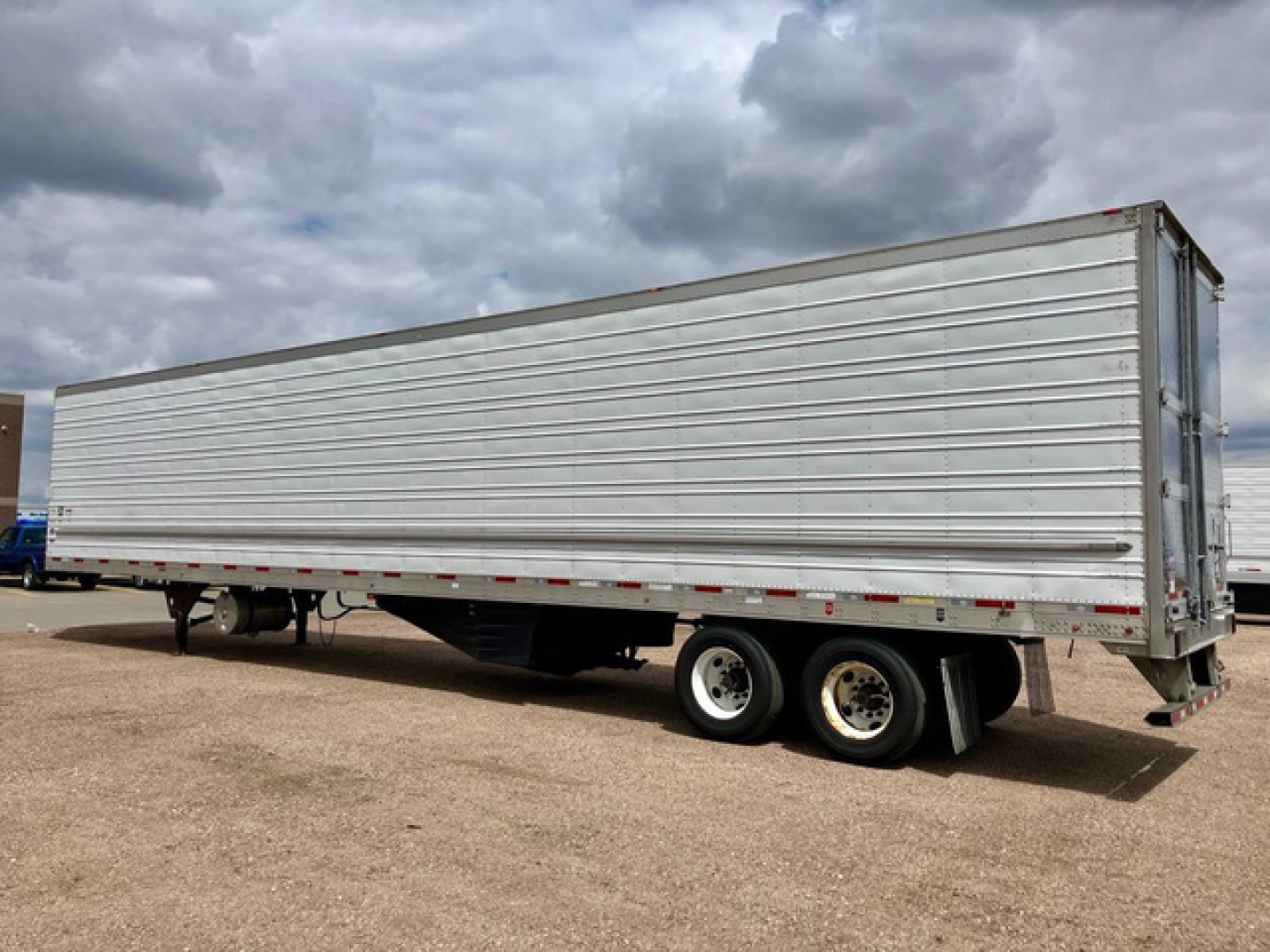2022 Utility Reefer trailer side view showing refrigerated trailer with tandem axles and metal siding.