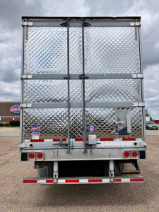 Rear view of a 2022 Utility reefer trailer with diamond plate aluminum doors, dual rear doors, taillights, and bumper; stock U90931, VIN 1UYVS2533N2486203.