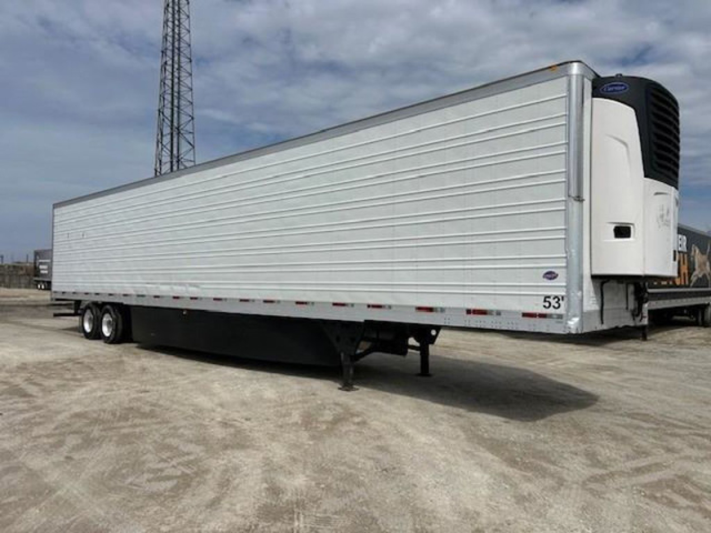 Refrigerated trailer in serviceable condition with a white insulated body and a rear refrigeration unit.
