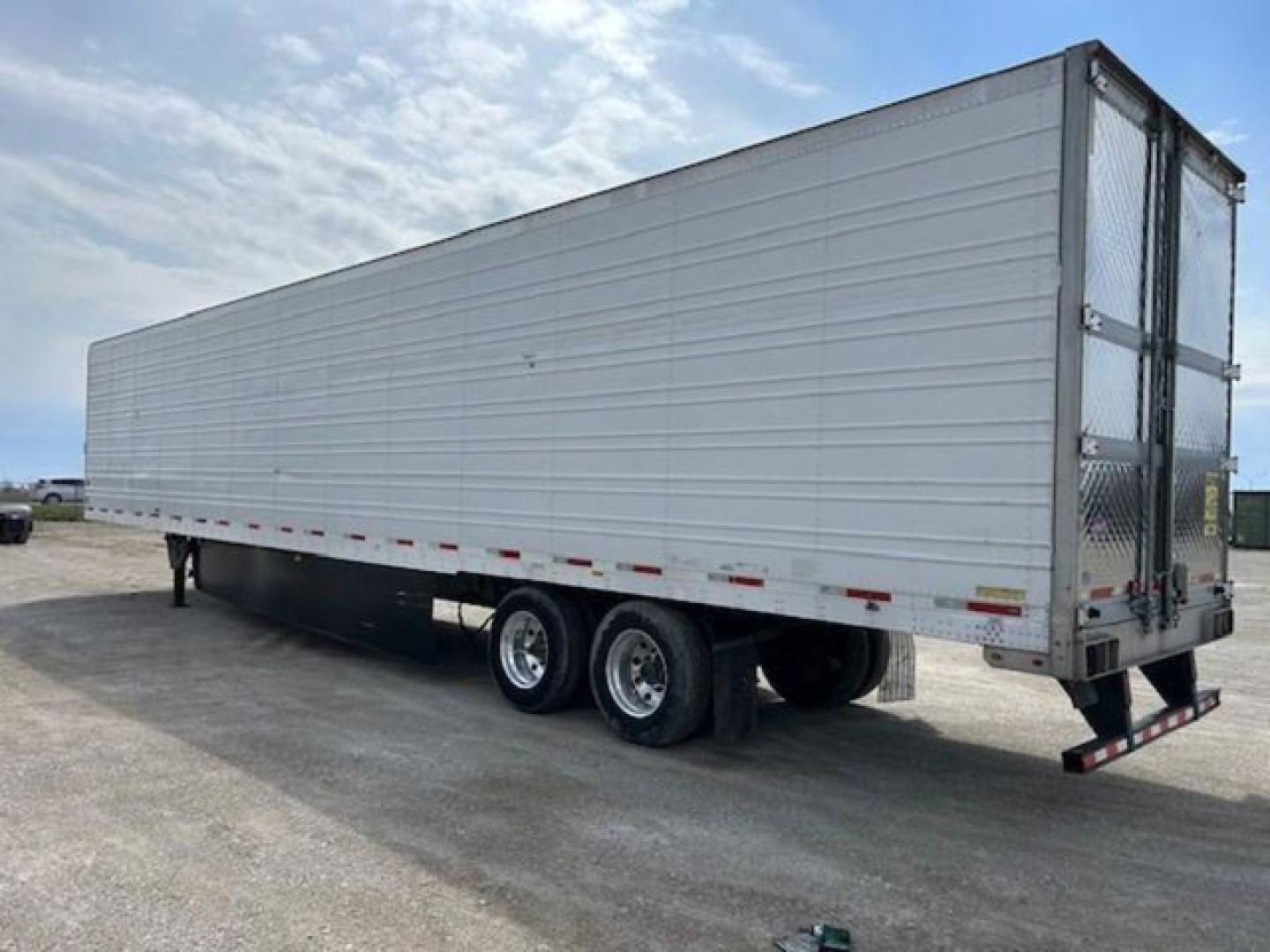 Trailer side view of a 2019 refrigerated utility trailer with tandem axles and a rear ramp door, labeled stock KTS1919.