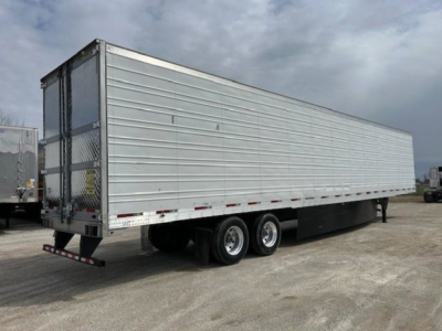 Trailer side view showing a 2019 Utility reefer trailer with silver aluminum siding, dual rear wheels, and a black undercarriage.