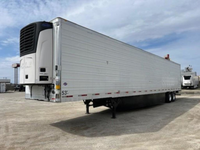 Trailer showing a refrigerated utility trailer with a front refrigeration unit and a raised landing gear. Side of trailer has 53' length markings and small stickers near the front.