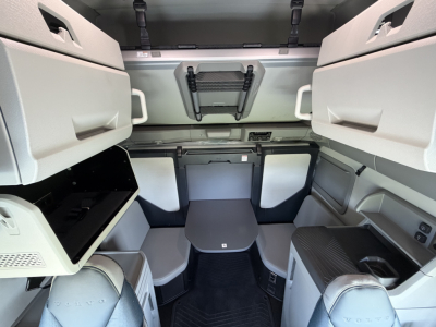Volvo VNL truck cab interior showing sleeper berth area with side cabinets and storage compartments.